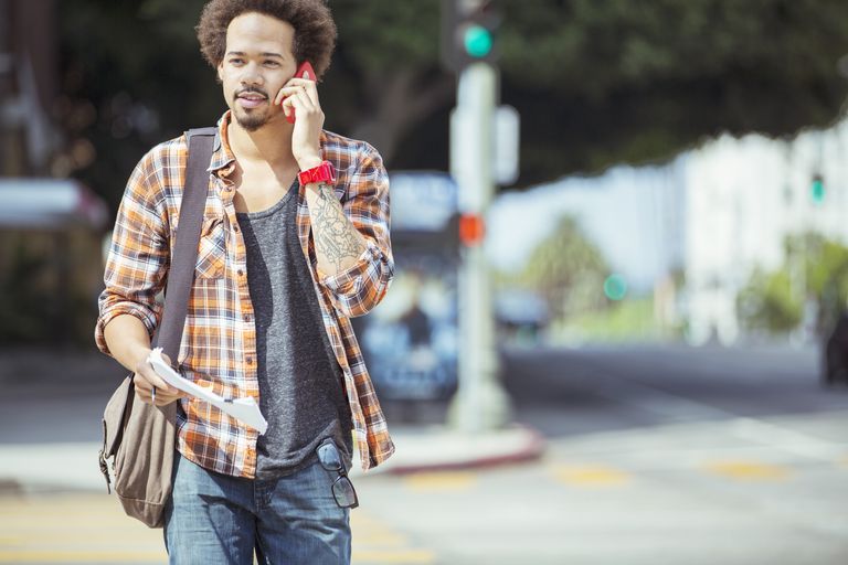 איש talking on cell phone in urban crosswalk